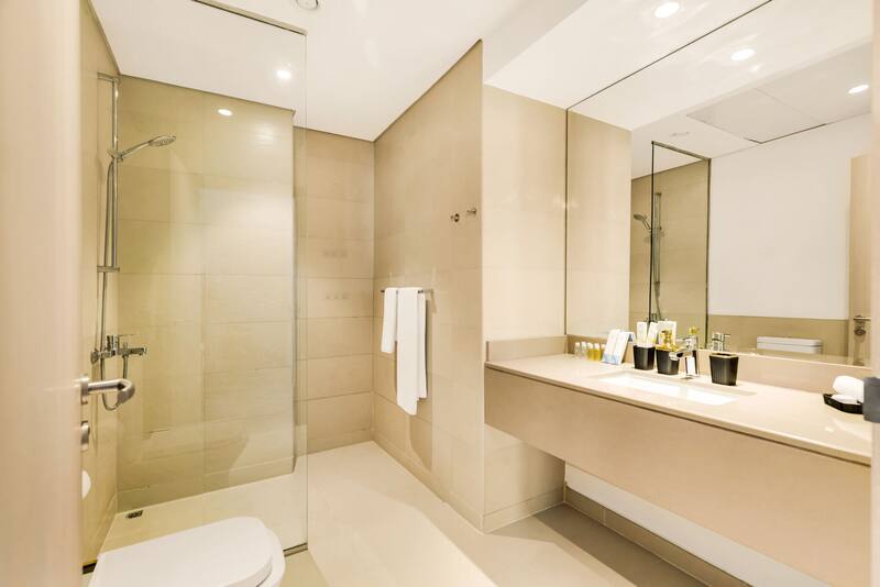 Bathroom with walk-in glass shower and vanity