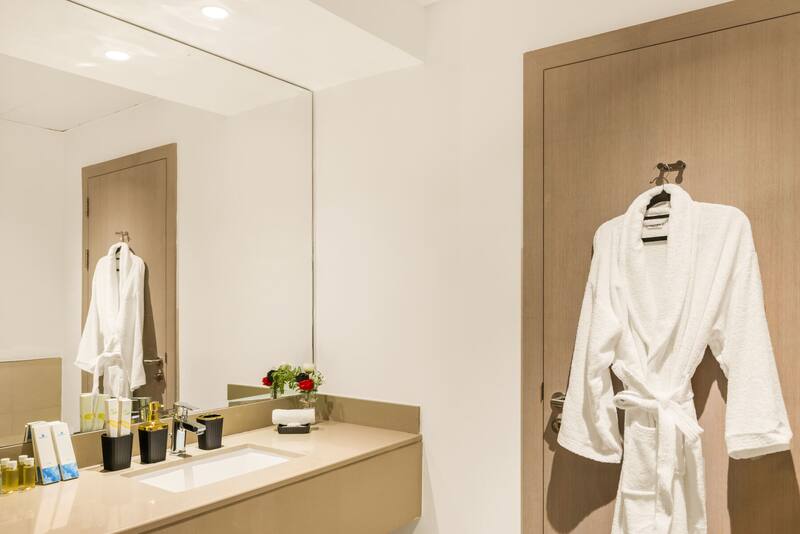 Bathrobe hanging in the bathroom beside the vanity