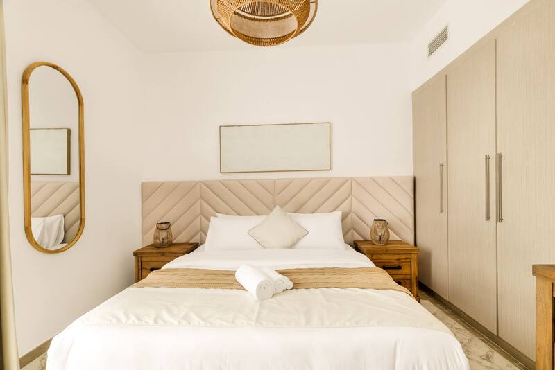 Bedroom with king bed, upholstered headboard and wardrobe
