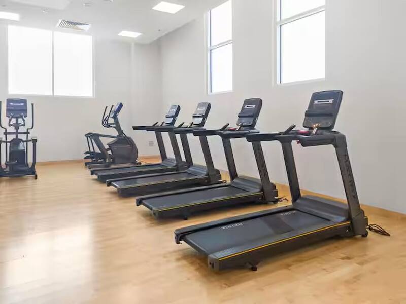Gym with a row of treadmills