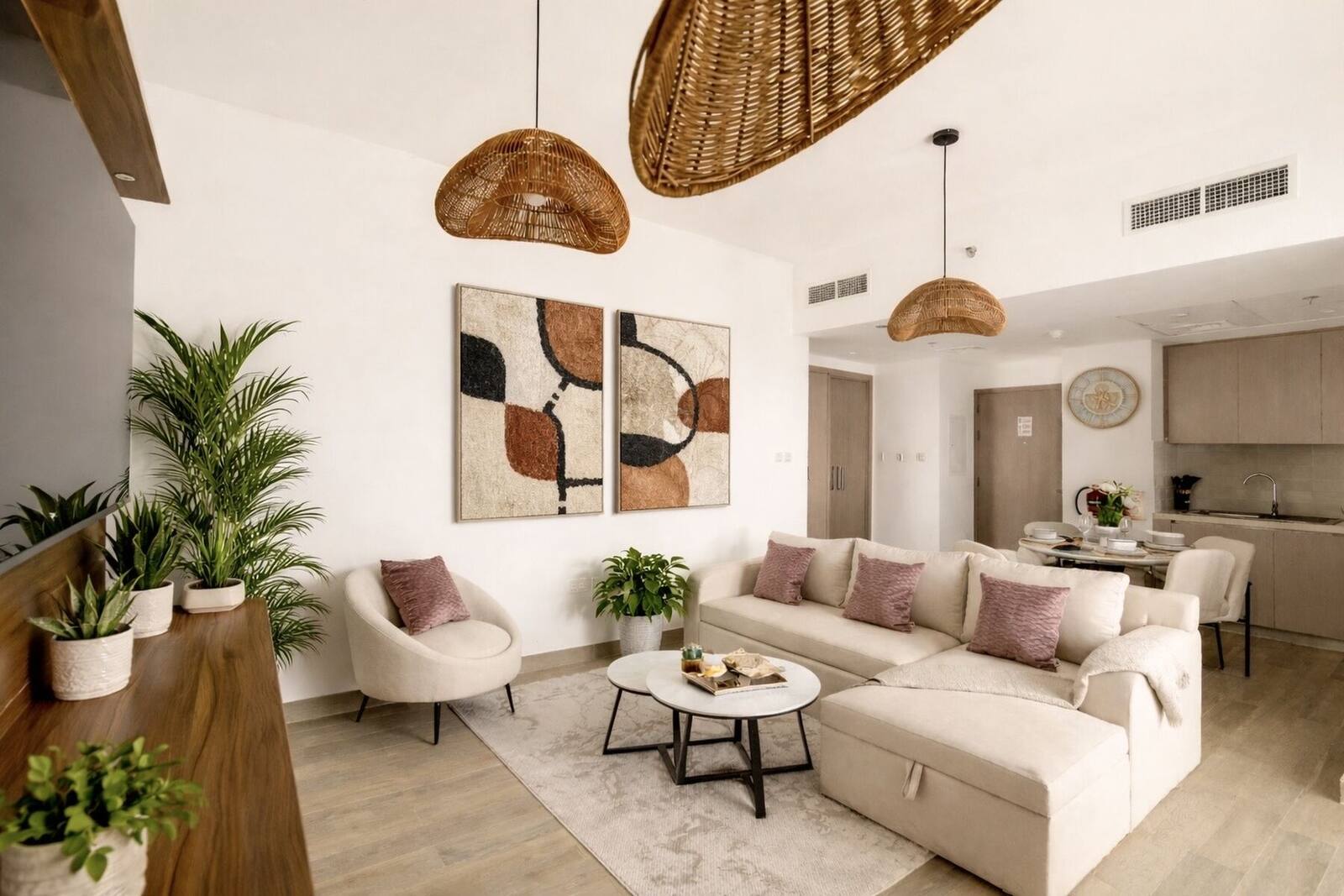 Open-plan living room with sofa, armchair and dining area